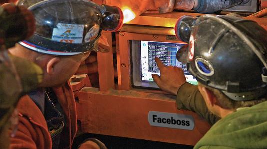 Miners looking at Faceboss screen