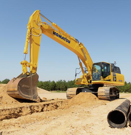 Komatsu PC290LCi excavator digging trench to lay pipe