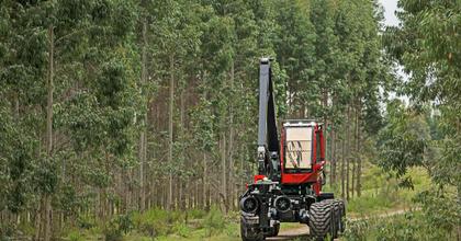 Komatsu forwarder driving on forested road
