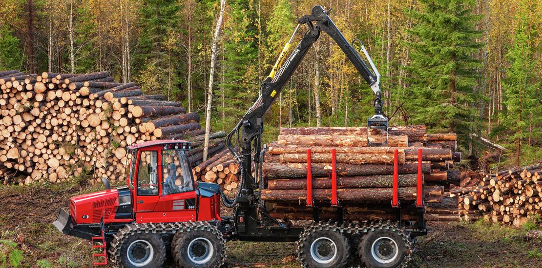 Komatsu 845 forwarder loading timber in clearing