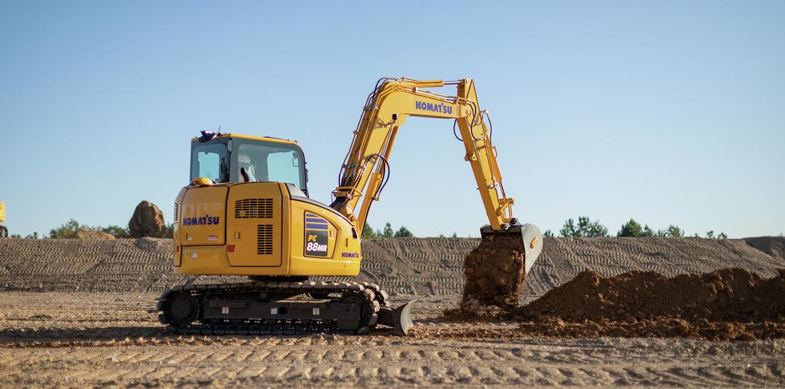 Komatsu PC88MR excavator dumping dirt