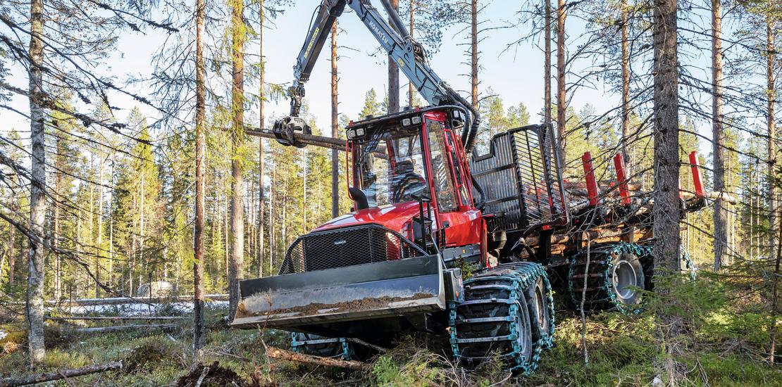 Komatsu 855 forwarder lifting timber in forest