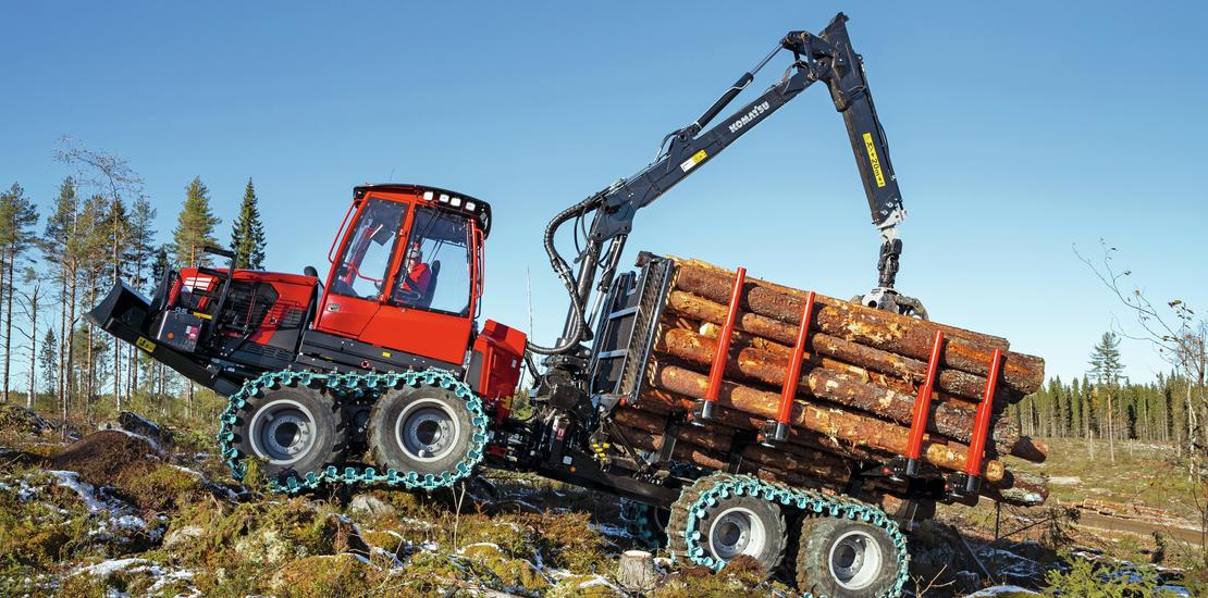 Komatsu 855 forwarder loaded with timber driving up incline