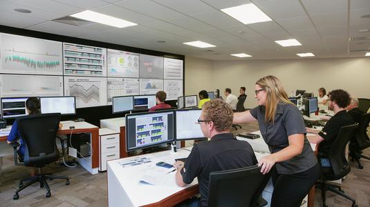 Komatsu employees remotely monitoring mining equipment health