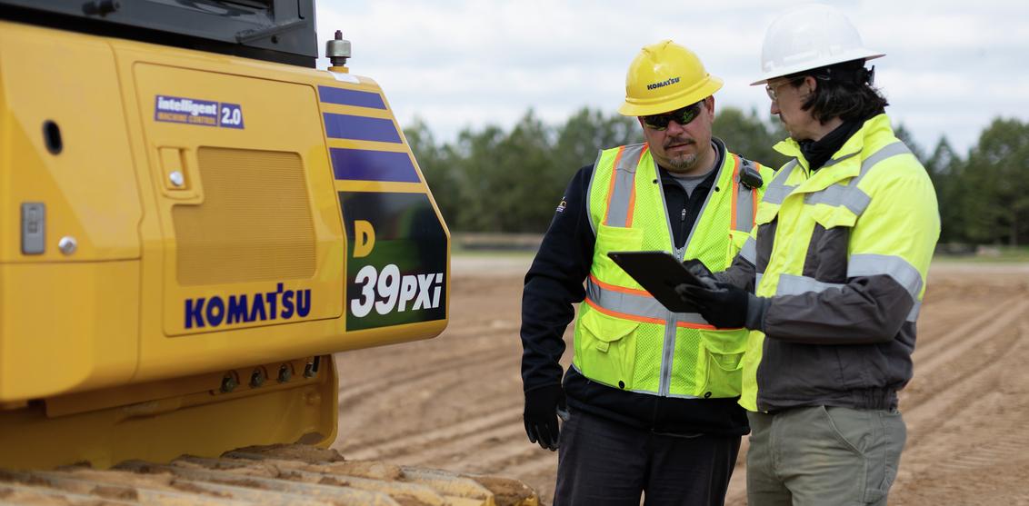 Two technicians next to Komatsu D39PXi dozer  CONEXPO-PR-2023