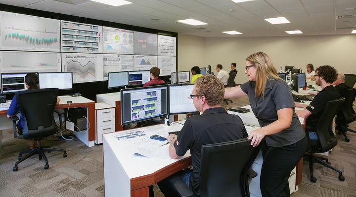 Komatsu employees remotely monitoring mining equipment health